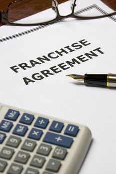 Image of a franchise agreement on an office table.