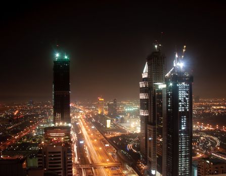 Towering city skyscraper blocks in Dubai at night