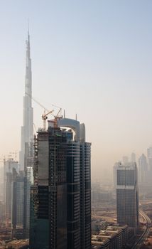 Towering city skyscraper blocks in Dubai with Burj