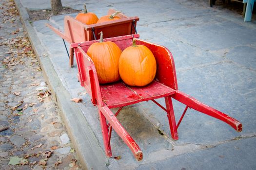 Two red barrows containing pumpkins - ancient town street
