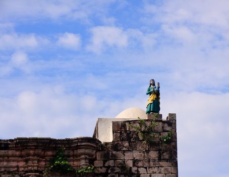 Painted statue of Christ and child on the roof of the old church in Kopala in Mexico