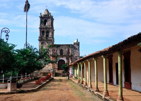 Ancient church in town square of Kopala with covered walkway to entrance