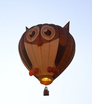 Hot air ballon in the air with the shape of an owl with eyes and ears