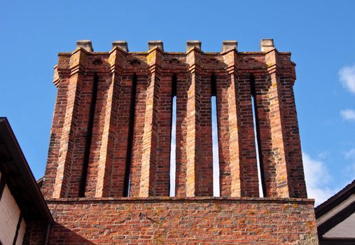 Ancient chimney stacks on old tudor house in England