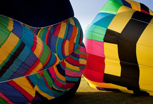 The canopies of two hot air balloons being inflated in close proximity
