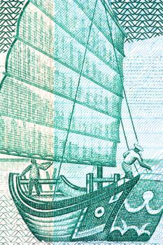 Macro image of a chinese junk on a currency note.
