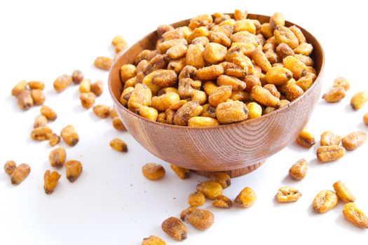 A cherry wood bowl of corn field on a white background.