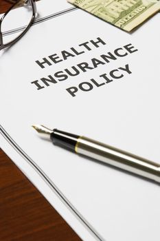 Image of a health insurance policy on an office table.