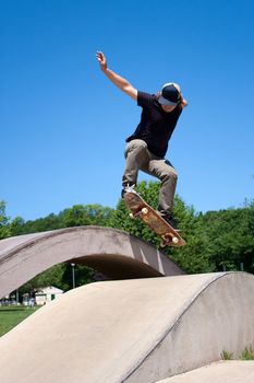 Action shot of a skateboarder performing a jump at a skate park.