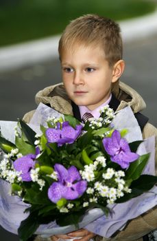 Litle boy with a bouquet of flowers
