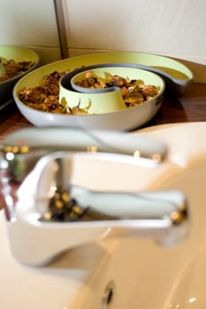 tap of a clean washbasin with ornament on the background