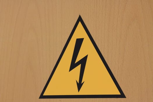 Close up of the high voltage sign on the wall.