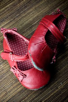 worn and dirty red baby girl shoes