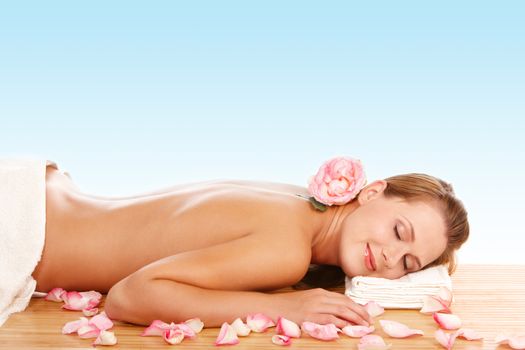 Young attractive woman lying and relaxing in spa center