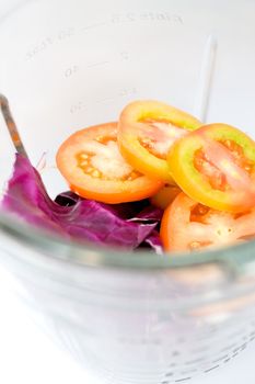 vegetables being prepared in the blender to make a vegetables juice