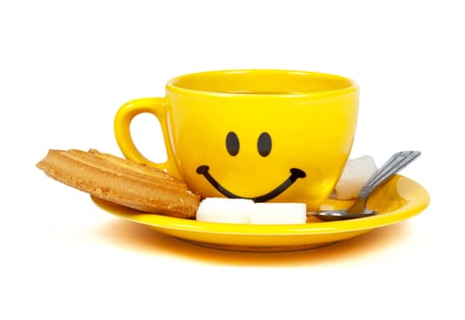 Happy yellow cup of tea with a cookie