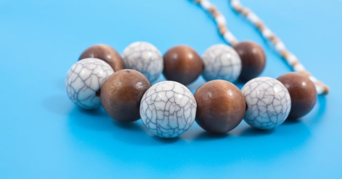 Photo of necklace placed on a blue background.