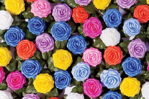 many-coloured plastics roses on a table