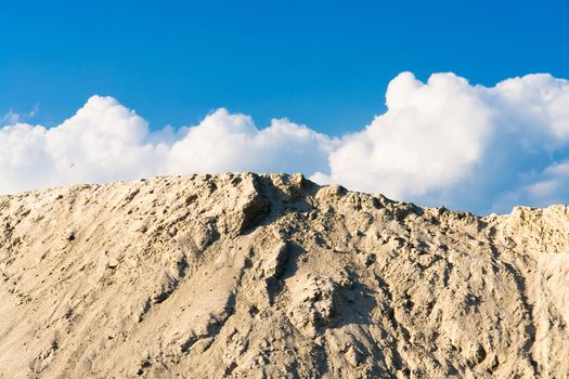  heap of sand on background blue sky