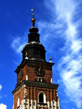 Monument tower with clock on sky background. Photo was taken in Cracow in Poland.