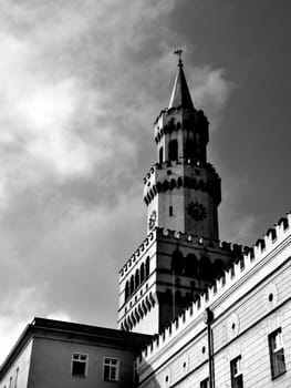 Town hall in Opole (Poland). Clouds and sky in the background. Photo is black and white. 