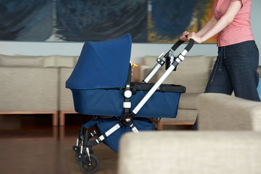 woman indoor with a stroller, slight motion blur
