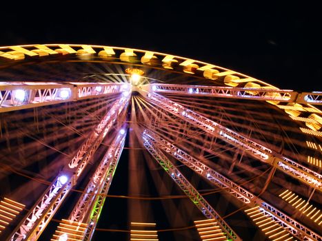 Spinning amusement park big wheel at night