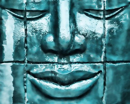 Zen statue made of stone with water dripping
