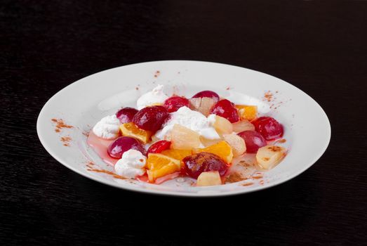 fruit salad of pineapple, grape, orange and strawberry with whipped cream