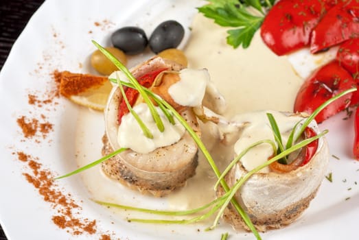fillet of pikeperch stuffed with trout fish with baked pepper, tomato and leek
