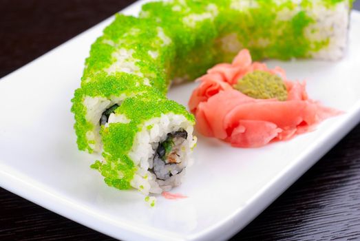 Sushi rolls made of salmon, avocado, flying fish roe - tobiko caviar and philadelphia cheese