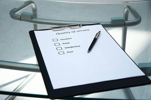 The questionnaire with marks about quality of service on a desktop