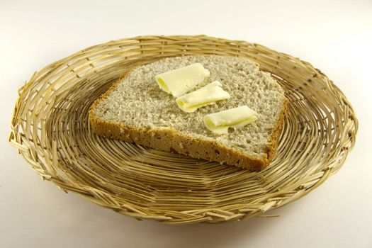 Plate with bread and butter isolated on white background