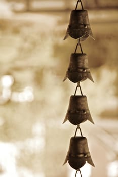 Brass bells at a shrine, sepia