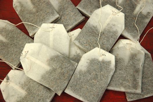 bunch of tea bags isolated on red background