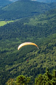 Paragliders floating above the hill of Puy de Dome in France