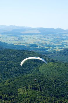 Paragliders floating above the hill of Puy de Dome in France