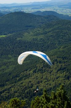 Paragliders floating above the hill of Puy de Dome in France