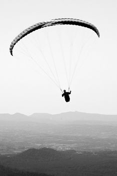 Paragliders floating above the hill of Puy de Dome in France