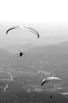 Paragliders floating above the hill of Puy de Dome in France