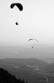 Paragliders floating above the hill of Puy de Dome in France