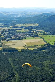 Paragliders floating above the hill of Puy de Dome in France