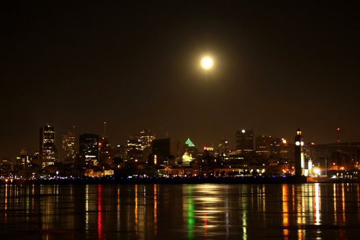 End of night full moon over Montreal cityscape
