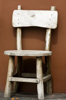 outdated wooden chair against the wall
