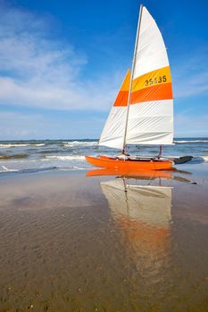 Catamaran vessel standing on a beach in Holland in summer