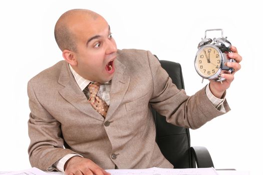 businessman looking at clock alarm at a desk