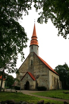 Estonia. Palamuse.Beautiful operating church on a background of trees