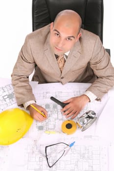 A businessman happiness with architectural plans at desk