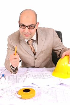 A businessman happiness with architectural plans at desk