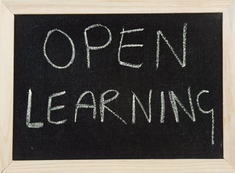 A black board with a wooden frame and the word 'OPEN LEARNING' written in chalk.